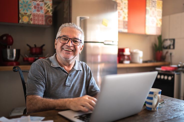 Senior adult reviewing Humana Medicare Advantage insurance plan options on a laptop at home